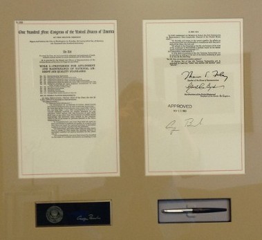 Ceremonial pen and papers in a frame.